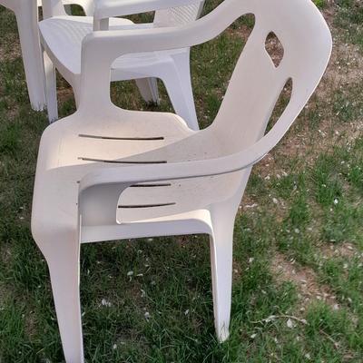 Three white plastic Patio chairs