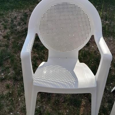 Three white plastic Patio chairs