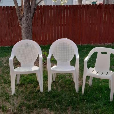 Three white plastic Patio chairs