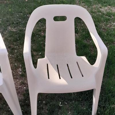 Three white plastic Patio chairs