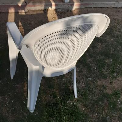 Three white plastic Patio chairs