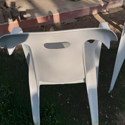 Three white plastic Patio chairs