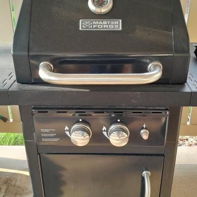 Master Forge Barbeque Grill with cleaning tools and propane tank