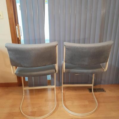 Two metal framed blue cushioned bar stools