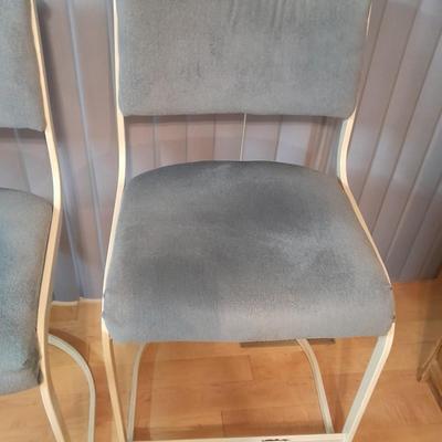 Two metal framed blue cushioned bar stools