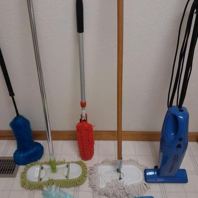 Cleaning tools, dusters, mops, and a Eureka Boss Vacuum broom