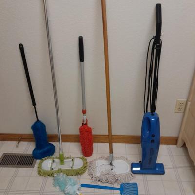 Cleaning tools, dusters, mops, and a Eureka Boss Vacuum broom