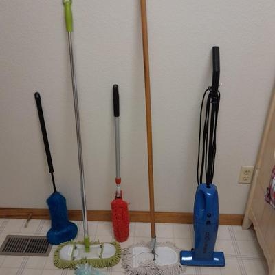 Cleaning tools, dusters, mops, and a Eureka Boss Vacuum broom