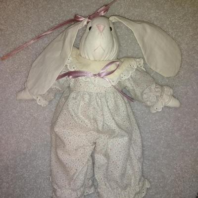 Four handcrafted bunnies and a wooden bench