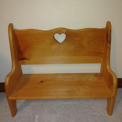 Four handcrafted bunnies and a wooden bench