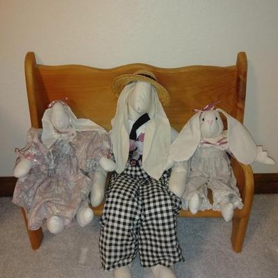 Four handcrafted bunnies and a wooden bench