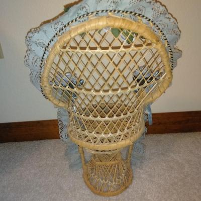 Teddybear in a wicker cane back chair, with handmade crocheted Doilies.