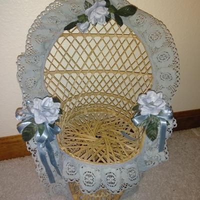 Teddybear in a wicker cane back chair, with handmade crocheted Doilies.