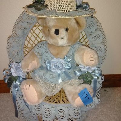 Teddybear in a wicker cane back chair, with handmade crocheted Doilies.
