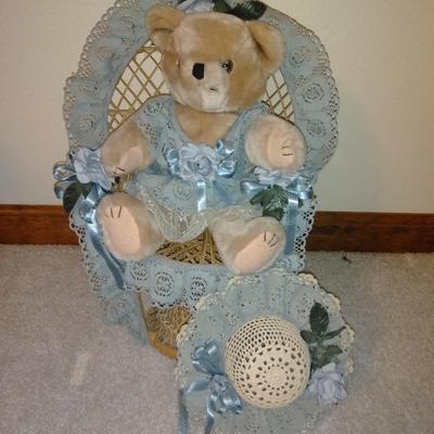Teddybear in a wicker cane back chair, with handmade crocheted Doilies.