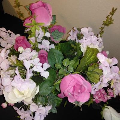 Two fake bouquet flowers in planters