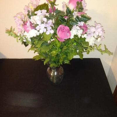 Two fake bouquet flowers in planters