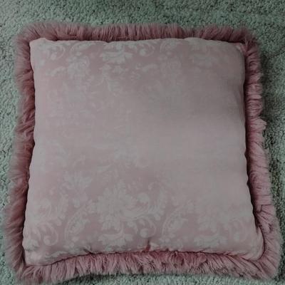 Two throw pillows and a gold framed wall mirror