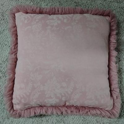 Two throw pillows and a gold framed wall mirror
