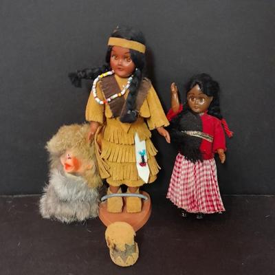 Two small vintage dolls with their furry monkey friend