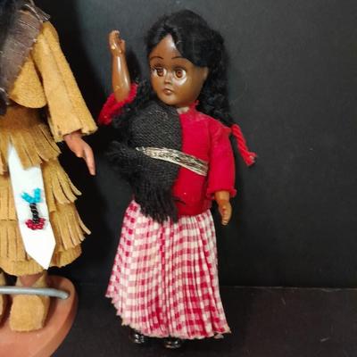 Two small vintage dolls with their furry monkey friend