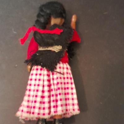 Two small vintage dolls with their furry monkey friend