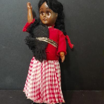 Two small vintage dolls with their furry monkey friend