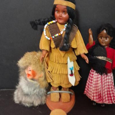 Two small vintage dolls with their furry monkey friend
