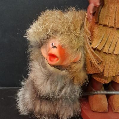 Two small vintage dolls with their furry monkey friend