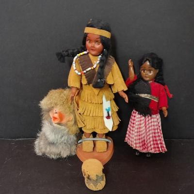 Two small vintage dolls with their furry monkey friend