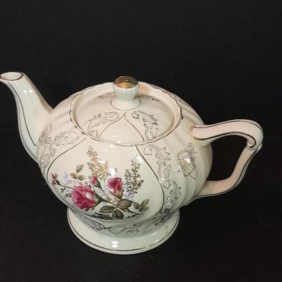 Lefton porcelain Angel, Teapot, Cup and saucer, and a silver-colored bell