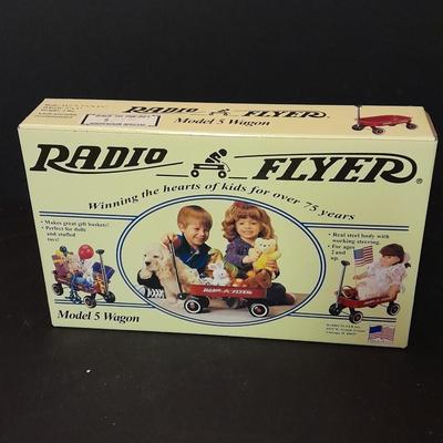 Radio Flyer wagon model and several vintage plush animals