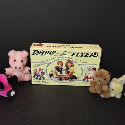 Radio Flyer wagon model and several vintage plush animals