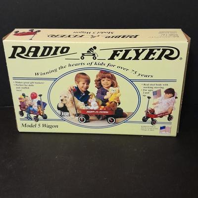 Radio Flyer wagon model and several vintage plush animals