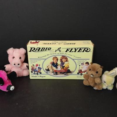 Radio Flyer wagon model and several vintage plush animals