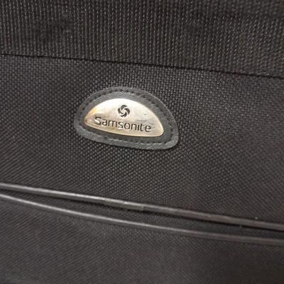Protool and Luggage, black leather-like case and Samsonite suitcase