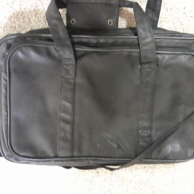 Protool and Luggage, black leather-like case and Samsonite suitcase