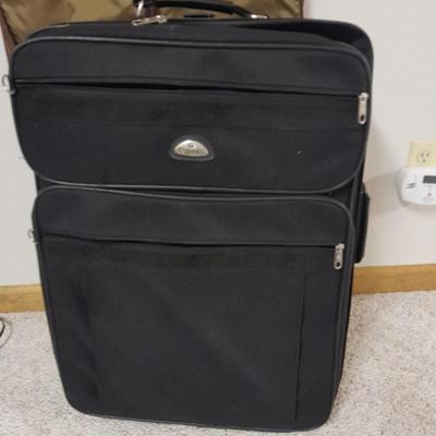 Protool and Luggage, black leather-like case and Samsonite suitcase