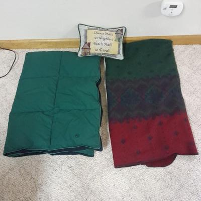 Two throw blankets, one down and a throw Pillow