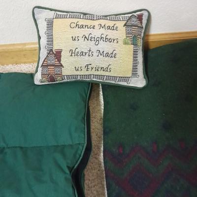 Two throw blankets, one down and a throw Pillow