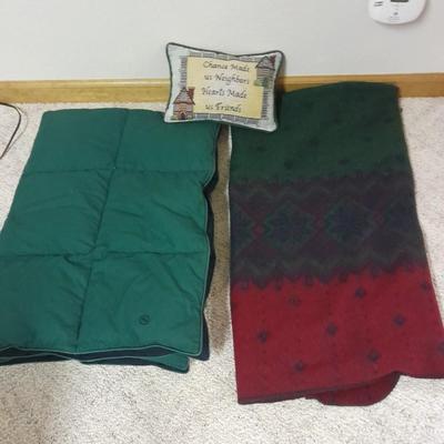 Two throw blankets, one down and a throw Pillow