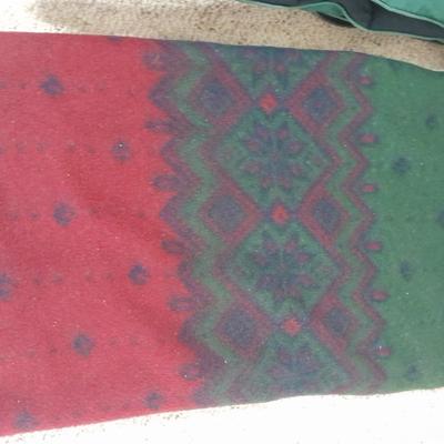 Two throw blankets, one down and a throw Pillow