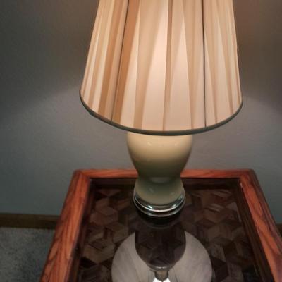 Glass top end table with Inlayed wicker design and a Lamp