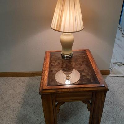 Glass top end table with Inlayed wicker design and a Lamp