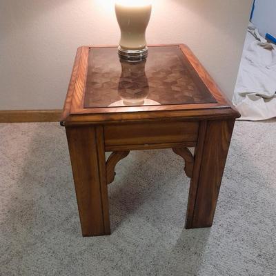 Glass top end table with Inlayed wicker design and a Lamp