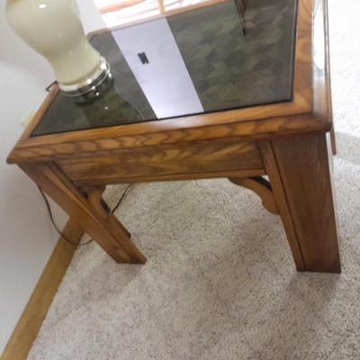 Glass top end table with Inlayed wicker design and a Lamp