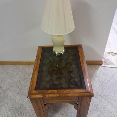 Glass top end table with Inlayed wicker design and a Lamp