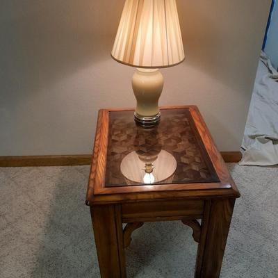 Glass top end table with Inlayed wicker design and a Lamp