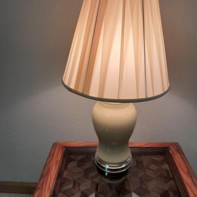 Glass top end table with Inlayed wicker design and a Lamp