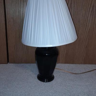 Cushioned wooden bar stool small lamp and an alarm clock
